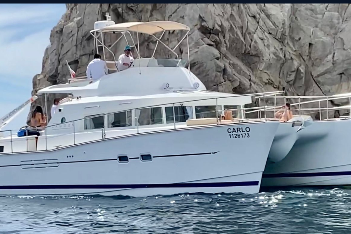 Cabo San Lucas catamaran cruising past the rocky coastline at Land's End